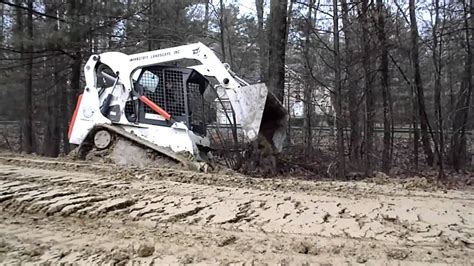 getting a skid steer unstuck|skid steer stuck in mud.